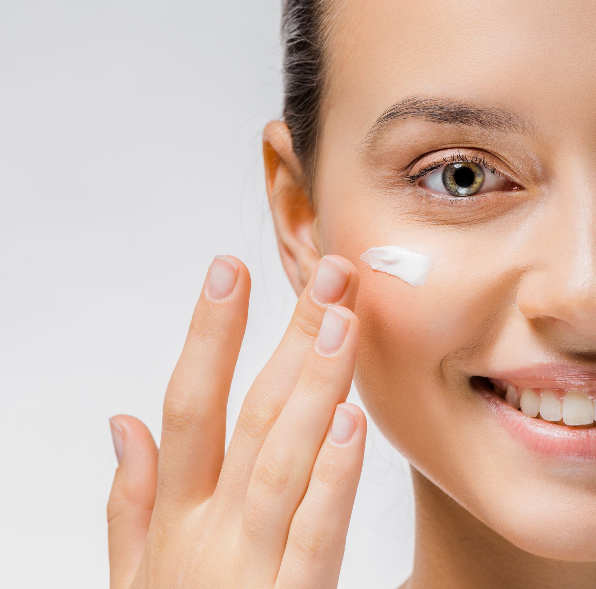 Lady applying cream on face